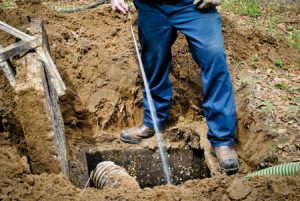 worker cleaning septic tank