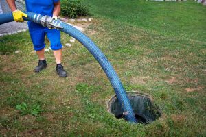 Man Pumping Out Septic Tank