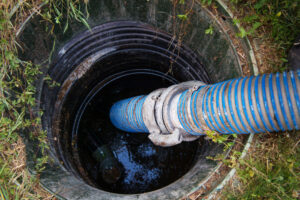 Emptying household septic tank. Cleaning sludge from septic system.