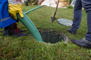 Workers emptying a septic tank at a residential property 